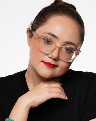 Close‑up professional studio portrait of Lauren Grace Zemel wearing glasses and office attire.