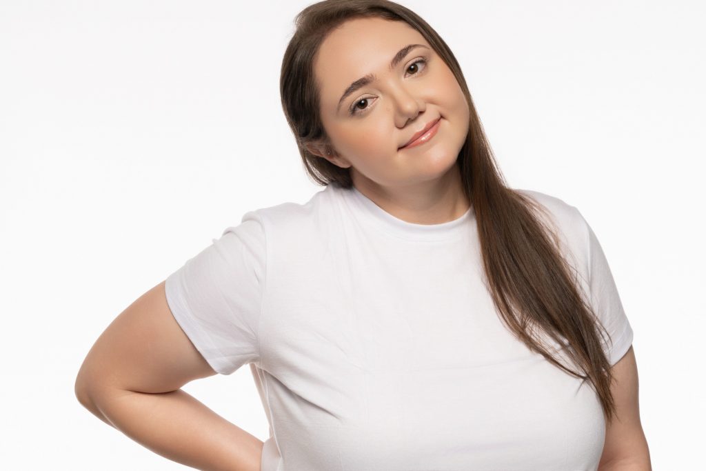 Lauren Grace Zemel standing straight on, white t-shirt, dark jeans, studio white background